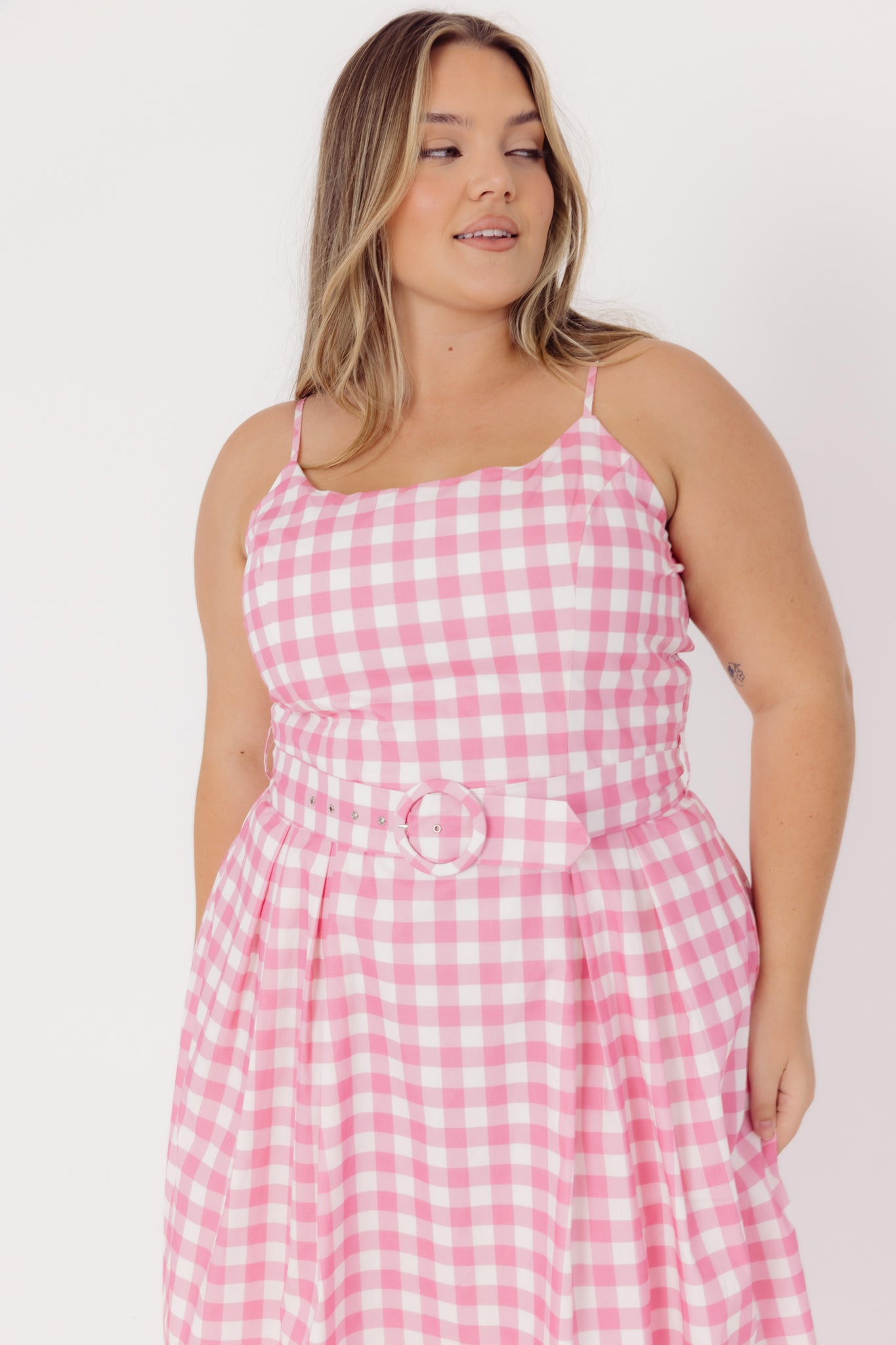 Close up front details of a woman wearing a Cherry bobbins pink and white gingham midi cotton dress 