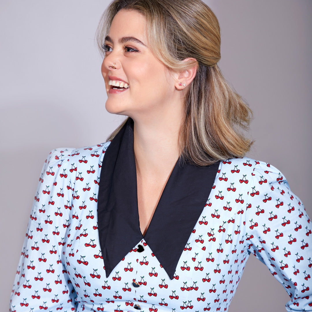 Founder of Cherry Bobbins, Cherisse Kofod's headshot wearing the Wednesday Blue Cherry Dress