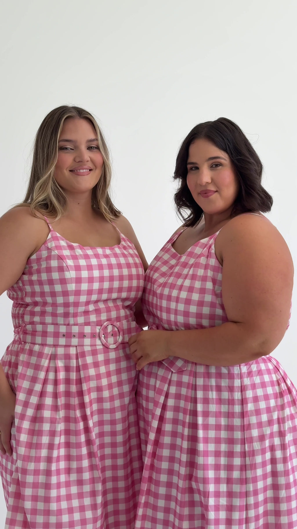 Style video of Picnic Pink Gingham Dress made from sustainable cotton and displayed on 2 models, sizes 16 & 20. This style comes with pockets and a self-covered belt.  